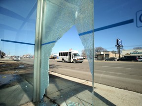 A bus shelter with broken glass