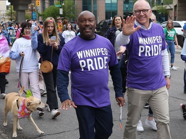 City councillors Markus Chambers (left) and Scott Gillingham walk in the Pride Winnipeg parade through downtown on Sunday, June 5, 2022.
