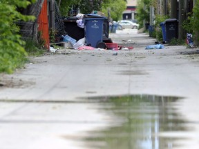 Garbage and recycling spills out into the back lane in the 400 block of Boyd Avenue in Winnipeg on Wed., June 8, 2022. Police say a newborn girl was left to die in an area trash bin on May 3.  KEVIN KING/Winnipeg Sun/Postmedia Network