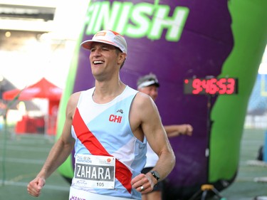 Michael Zahara crosses the finish line of the Manitoba Marathon at IG Field in Winnipeg on Sunday, June 19, 2022.