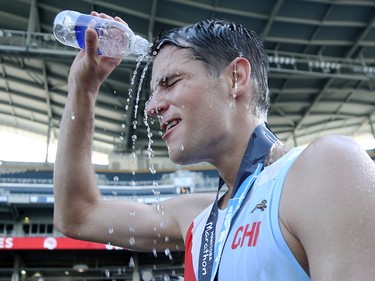 Michael Zahara pours water on himself after the Manitoba Marathon at IG Field in Winnipeg on Sunday, June 19, 2022.