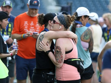 Christie Paterson (right) and Jade Hopkins hug after the Manitoba Marathon at IG Field in Winnipeg on Sunday, June 19, 2022.
