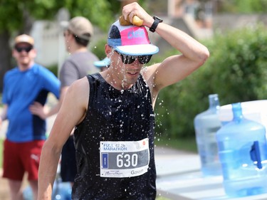 A runner cools off along Pembina Highway during the Manitoba Marathon in Winnipeg on Sunday, June 19, 2022.