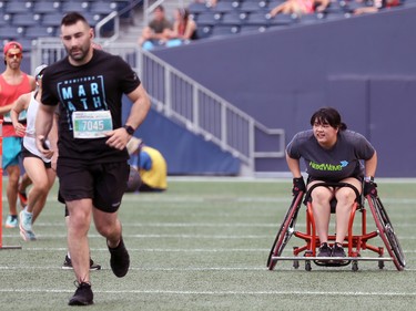 A wheelchair competitor pushes across the artificial turf at IG Field during the Manitoba Marathon in Winnipeg on Sun., June 19, 2022. KEVIN KING/Winnipeg Sun/Postmedia Network