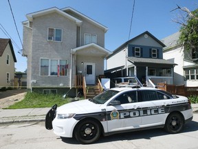 A police cruiser sits outside a duplex in the 500 block of Alexander Avenue in Winnipeg on Mon., June 27, 2022. Police said Aaron Ashton McKay, 31, of Winnipeg, was shot while there was a gathering of people there Sunday morning. McKay was taken to hospital where he succumbed to his injuries. The homicide unit is investigating.