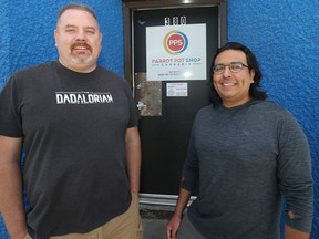 Josh Giesbrect (right) with Parrot Pot Shop owner Stephen Lamoureux in front of his store on Selkirk Avenue in Winnipeg on Tues., June 28, 2022. Parrot is the first to sign on to The Half Circle mobile app cannabis delivery service developed by Giesbrecht. KEVIN KING/Winnipeg Sun/Postmedia Network