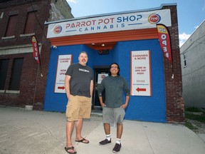 Josh Giesbrect (right) with Parrot Pot Shop owner Stephen Lamoureux in front of his store on Selkirk Avenue in Winnipeg on Tues., June 28, 2022. Parrot is the first to sign on to The Half Circle mobile app cannabis delivery service developed by Giesbrecht. KEVIN KING/Winnipeg Sun/Postmedia Network