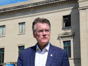 Manitoba Liberal leader Dougald Lamont speaks during a news conference outside the Manitoba Legislature on Tuesday, July 12.