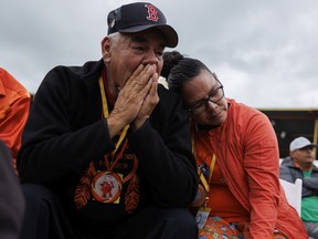 People react as Pope Francis issues an apology for the treatment of First Nations in Canada's Residential School system his visit to Maskwacis, Alta., on July 25, 2022. The Pope is touring Canada, meeting with Indigenous communities and community leaders in an effort to reconcile the harmful legacy of the church's role in Canada's residential schools.