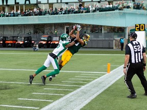 Edmonton Elks’ Kenny Lawler has an incomplete pass  as he’s tackled by Saskatchewan Roughriders’ Nick Marshall.