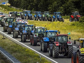 Farmers take part in a blockade of the A67 near Eindhoven to protest against government plans that may require them to use less fertilizer and reduce livestock at Hapert, on July 4, 2022. (Photo by ROB ENGELAAR / ANP / AFP) / Netherlands OUT (Photo by ROB ENGELAAR/ANP/AFP via Getty Images)
