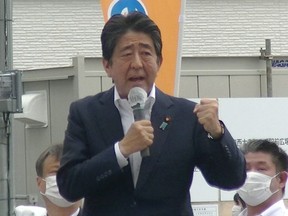This image taken from video provided by witness Toshiharu Otani and released via Jiji Press shows former Japanese prime minister Shinzo Abe delivering an election campaign speech at Kintetsu Yamato-Saidaiji station square in Nara before he was shot.