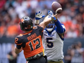 Winnipeg Blue Bombers' Willie Jefferson (5) blocks a pass attempt by B.C. Lions quarterback Nathan Rourke (12) during the first half of CFL action in Vancouver, on Saturday, July 9.