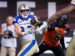 Winnipeg Blue Bombers' Dalton Schoen, left, makes a reception in the end zone to score a touchdown as B.C. Lions' T.J. Lee defends during the first half of CFL football action in Vancouver on Saturday, July 9.