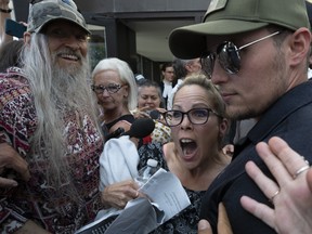 Supporters surround ÔFreedom ConvoyÕ organizer Tamara Lich as she leaves the courthouse after being released from jail, Tuesday, July 26, 2022 in Ottawa. THE CANADIAN PRESS/Adrian Wyld