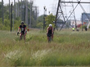 Two cyclists use an active transit path in Winnipeg on Thursday, July 7, 2022. Ground has been broken on the new Northwest Hydro Corridor Multi-use Path Project.