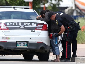 Police with a member of the public at The Forks, in Winnipeg on Friday, July 8. In recent weeks there have been people randomly attacking, stabbing and robbing at this location, some of the attackers have been as young as twelve, police are now patrolling the area more frequently.