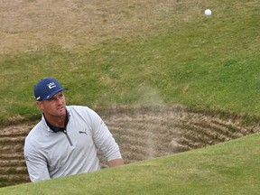 US golfer Bryson DeChambeau plays from the road hole bunker during a practice round for The 150th British Open Golf Championship on The Old Course at St Andrews in Scotland on July 13, 2022.