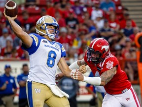 Winnipeg Blue Bombers quarterback Zach Collaros throws under pressure from Cameron Judge of the Calgary Stampeders during CFL football in Calgary on Saturday, July 30, 2022. Collaros is a finalist for the CFL's Most Outstanding Player award. If he wins it would be his second straight MOP award. Al Charest/Postmedia
