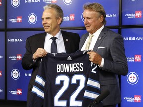 Kevin Cheveldayoff Executive Vice President & General Manager presents Winnipeg Jets Head Coach Rick Bowness his personalized Winnipeg Jets jersey during the press conference at Canada Life Centre on July 4, 2022.