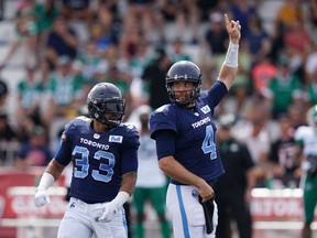 Toronto Argonauts' quarterback McLeod Bethel-Thompson, right, signals a call in front of teammate Andrew Harris looks to pass during the first half of CFL action against the Saskatchewan Roughriders at Acadia University in Wolfville, N.S., Saturday, July 16, 2022. Harris moved past Hall of Fame receiver Milt Stegall into fourth in all-time yards from scrimmage.