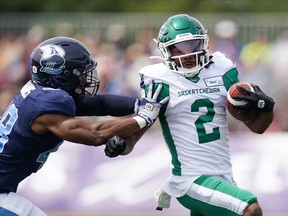 Saskatchewan Roughriders' Mario Alford, right, avoids a tackle by Toronto Argonauts' Wynton McManis during the first half of CFL action at Acadia University in Wolfville, N.S., Saturday, July 16, 2022.&ampnbsp;McManis returned an interception 50 yards for a touchdown in a separate play to rally the Toronto Argonauts to a 30-24 win over the Saskatchewan Roughriders in an entertaining but often chippy Touchdown Atlantic game Saturday afternoon.