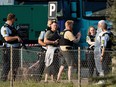 A policeman takes a picture of a man detained and believed to be the suspect, at the Fields shopping center in Copenhagen, Denmark, on July 3, 2022.