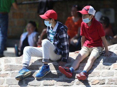 Two people wear masks while at The Forks in Winnipeg on Friday, July 1, 2022.