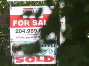 A sold sign on a home for sale sign