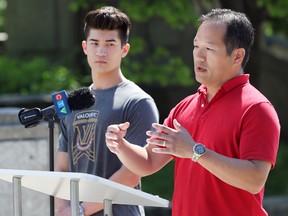 Garret Wong (right), with his son Nathan, speaks about them nearly drowning while boating in June during a Lifesaving Society Manitoba press conference behind the Manitoba Legislative Building in Winnipeg on Monday, July 18, 2022.