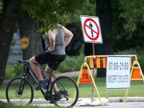 A cyclist uses a road that is closed to vehicular traffic in Winnipeg on Tuesday, July 26, 2022.