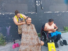 Over the past few weeks and months, Winnipeg hairstylist Jennifer Woodhouse has been setting up a small station near the corner of Main Street and Dufferin Avenue in Winnipeg for a few hours every second Saturday, and offering free haircuts to those who otherwise could not afford one. Handout photo