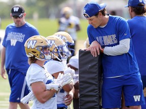 Receivers Dalton Schoen (left) and Greg Ellingson get ready for a blocking drill during Winnipeg Blue Bombers practice.
