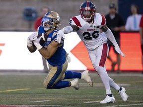 Winnipeg Blue Bombers running back Brady Oliveira catches a pass in front of Montreal Alouettes linebacker Tyrice Beverette Thursday. Paul Chiasson/THE CANADIAN PRESS