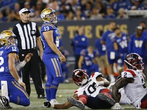 Winnipeg Blue Bombers kicker Marc Liegghio (13) reacts as he watches his field goal attempt go wide during overtime of CFL action against the Montreal Alouettes in Winnipeg Thursday, August 11, 2022.    THE CANADIAN PRESS/John Woods