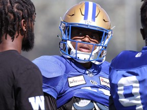 Blue Bombers defensive back Jamal Parker speaks with Demerio Houston at practice yesterday.