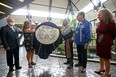 Carlos Barcenos from the Royal Canadian Mint, Anita Campbell from the Manitoba Metis Federation, elder Norman Meade, Minister of Northern Affairs Dan Vandal, and artist Jennine Krauchi (from left) unveil a new coin honouring the Red River Metis at the Mint in Winnipeg on Tues., Aug. 2, 2022.