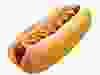 An old-fashioned hot dog with mustard, on a sesame seed bun.
