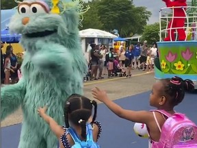 In this image from video provided by Jodi Brown, posted to Instagram on Saturday, July 16, 2022, a performer dressed as the character Rosita waves off Brown's daughter and another 6-year-old Black girl at the Sesame Place amusement park in Langhorne, Pa.