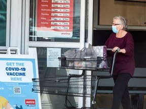 A shopper leaves a Metro grocery store in Mississauga on Oct. 20, 2021.