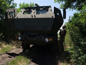 A Ukrainian serviceman opens the door to a vehicle equipped with a High Mobility Artillery Rocket System in eastern Ukraine on July 1. MUST CREDIT: Photo for The Washington Post by Anastasia Vlasova.