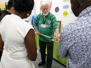 A volunteer holds a hurley (stick) and a sliotar (ball) from the sport of hurling in the cultural display area at the Folklorama Irish Pavilion at Soul Sanctuary on Chevrier Boulevard in Winnipeg on Monday, Aug. 1, 2022.