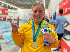 Selkirk's Teagen Purvis, 19, celebrates after winning the gold medal in swimming's 100m backstroke Special Olympics event at the 2022 Canada Summer Games in Niagara, Ont., on Tuesday, Aug. 9, 2022. It was her second gold and third medal of the Canada Gams, following a gold in the 100m freestyle Special Olympics event and a silver in the 50m breaststroke Special Olympics event on Monday.