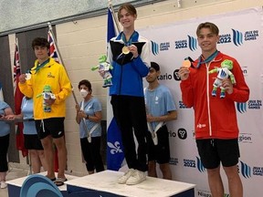Winnipeg's Adam Cohen (left) celebrates winning silver medal in diving's three-metre artistic event at the 2022 Canada Summer Games in Niagara, Ont., on Tuesday, Aug. 16, 2022.