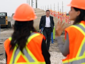 Transportation Minister Doyle Piwniuk (centre) arrives at a highway construction site on the south Perimeter Highway near St. MaryÕs Road in Winnipeg on Mon., Aug. 15, 2022. KEVIN KING/Winnipeg Sun/Postmedia Network