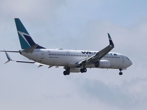 A WestJet plane in the sky above Winnipeg on Wednesday, Aug. 17.  Chris Procaylo/Winnipeg Sun