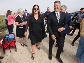 Premier Heather Stefanson (left) and Mayor Brian Bowman walk to the podium together for a press conference to announce tri-level funding for sewage treatment plant upgrades near the North End Water Pollution Control Centre in Winnipeg on Tuesday, Aug. 16, 2022.