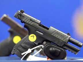 Handguns with obliterated serial numbers on display during a press conference at Winnipeg Police Service headquarters on Tuesday, Aug. 16, 2022.