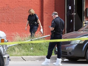 Forensics unit officers work a homicide scene on Jarvis Avenue at Main Street in Winnipeg on Mon., Aug. 22, 2022.