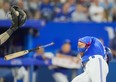 Lourdes Gurriel Jr. of the Toronto Blue Jays drops his bat after getting hit by a pitch against the Chicago Cubs in the sixth inning at the Rogers Centre on August 31, 2022 in Toronto.
